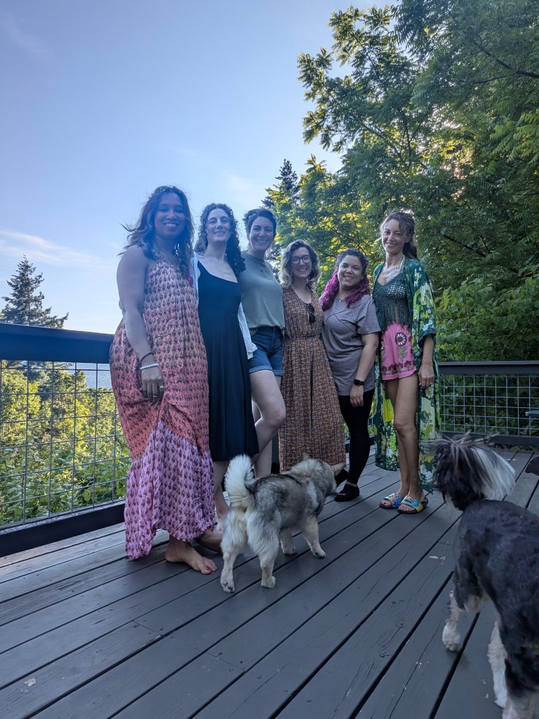 A group of women pose side by side in a friendly way